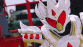 a close up of a white and red costume