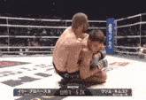 two men are wrestling in a boxing ring and the clock says 5:24