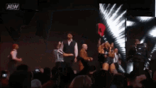 a group of people standing on a stage with one wearing a shirt that says ' a '