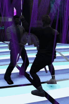 two men are standing on a dance floor in front of a neon sign that says ' a '