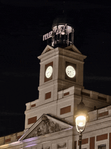 a clock tower with a sign on top that says feliz 2020