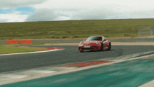 a red sports car is driving on a track with a license plate that says ' sg ' on it