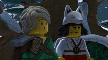 a couple of lego figures are standing next to each other and one of them is wearing a fox mask .