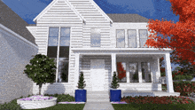 a white house with a porch and a tree with red leaves in front of it