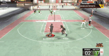 a basketball game is being played on a court with a plumbing sign in the background