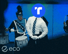 a man in a marching band playing drums with a blue circle with the letter r on it