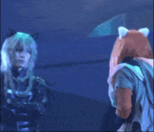 a man and a woman are standing next to each other in a blue room