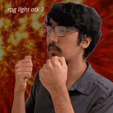 a man wearing glasses holds his fist up in front of a fire background with the words rpg light atk 3