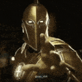 a man in a knight 's helmet is pointing at the camera .