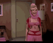 a woman in a pink costume is dancing in a room .