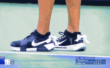 a person wearing a pair of black nike shoes