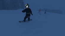 a person on a snowboard with a helmet on their head that says ' nintendo '