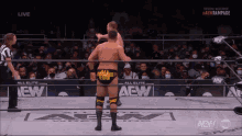 a wrestler with the word ego on his shorts is in the ring