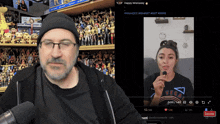 a man and a woman are sitting in front of a screen that says subscribe on it