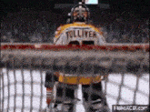 a hockey goalie with the name tolliver on his back