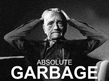 a black and white poster for absolute garbage with a man holding his head