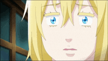 a close up of a girl 's face with blue eyes and yellow hair