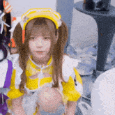 a girl in a maid outfit is kneeling down and looking at the camera