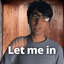 a man wearing glasses and a grey shirt says let me in