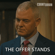 a man in a suit and tie says the offer stands in front of a countdown logo