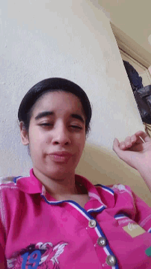 a young girl wearing a pink shirt with the word barbie on it