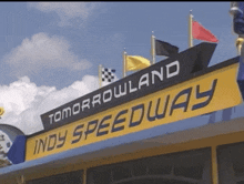 a sign for tomorrowland indy speedway hangs from a building