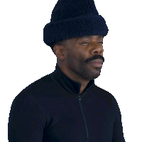 a man wearing a hat and a black jacket says " okay wait "