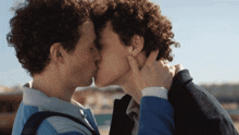 a couple of men kissing with a watermark that says ' unanswerable '