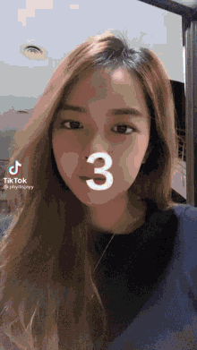 a woman 's face is shown with the number 3 on it