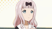 a girl with a bow in her hair is being touched by another girl