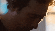 a close up of a man 's face with a blurred background
