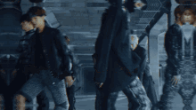 a group of people are walking down a hallway with the number 141 in the corner