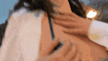 a close up of a woman 's neck with a man 's hand