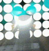 a person is standing in front of a wall of white dots