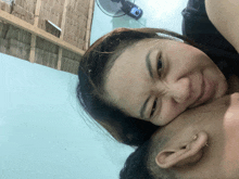 a woman laying on top of a man 's head