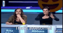 a man and a woman sitting at a table with the words that 's awesome abbass on the screen