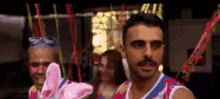 a man with a mustache is wearing a red white and blue tank top that says ' sydney ' on it