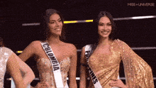 two miss universe contestants are posing for a picture