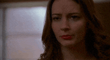 a close up of a woman 's face with red lipstick on her lips .