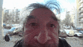 a close up of a man 's face with a van that says volkswagen on it