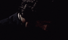 a close up of a man 's face with a black background