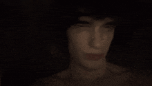 a close up of a person covering their mouth with their hand