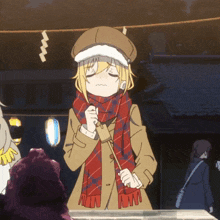 a girl wearing a hat and scarf is holding a stick with the letter w on it