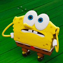 a cartoon character named spongebob is standing on a green wooden floor