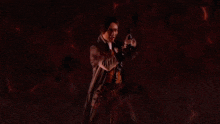 a close up of a man holding a sword in his hand .