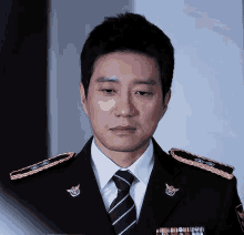 a man in a military uniform has a badge on his collar that says ' police ' on it