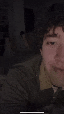 a close up of a person 's face with a dark background