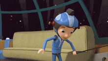 a cartoon character wearing a blue helmet is standing next to a tan couch