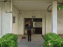 a man is standing in front of a building with a sign that says ' stairs '