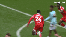 a soccer player in a red jersey with the number 24 on it